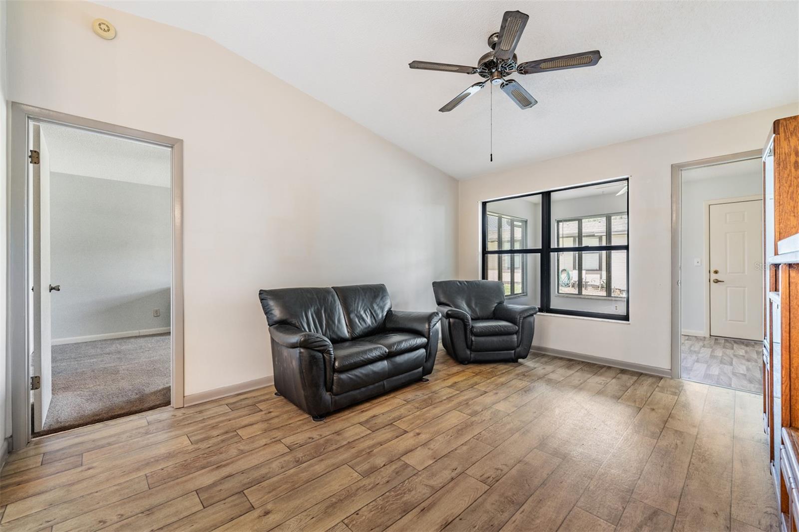 Family Room, just inside of the Florida Room, Laminate Flooring, high ceilings and ceiling fan.
