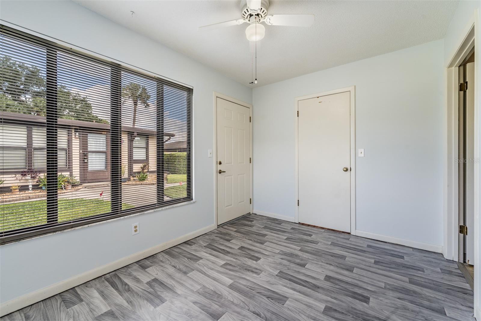 Lots of sunlight in the Florida Room...storage closet and ceiling fan with light.