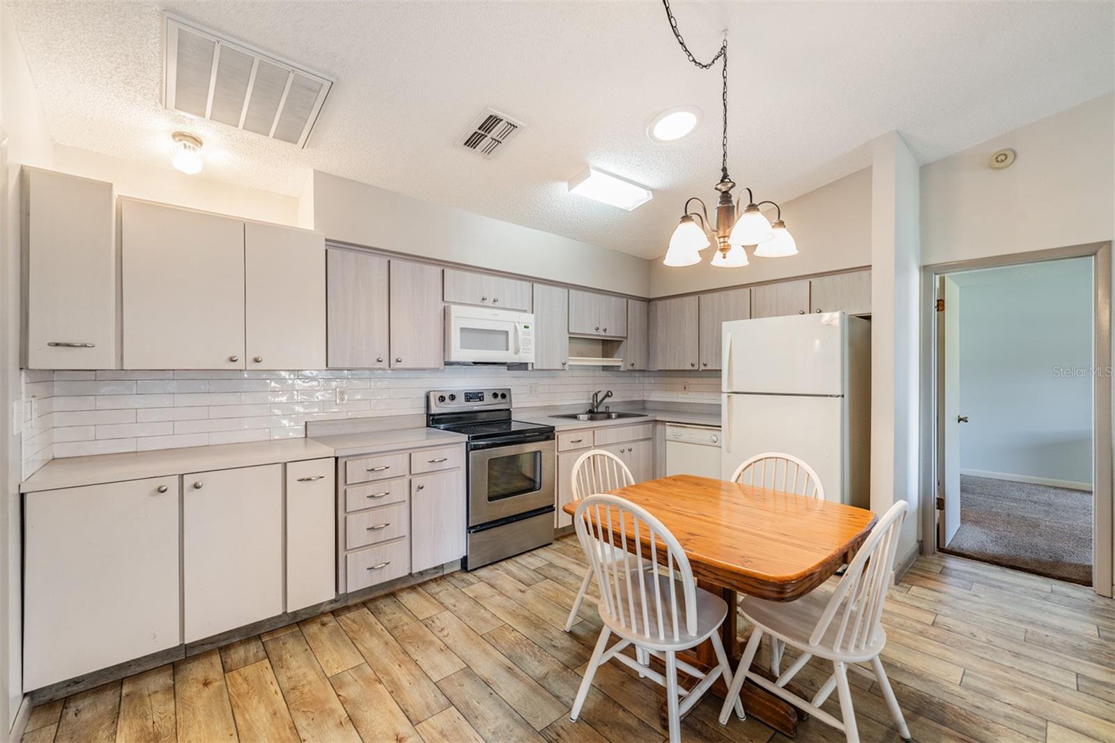 Open Kitchen, High Ceilings, lots of counter top space, dishwasher, range, refrigerator and microwave.