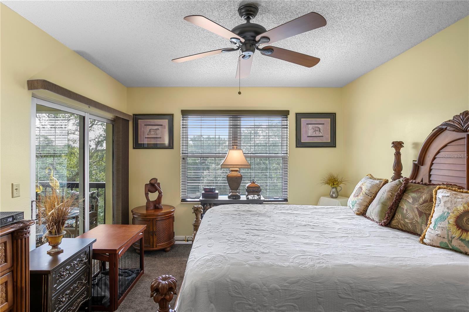 The primary bedroom offers direct access to the balcony for added outdoor enjoyment