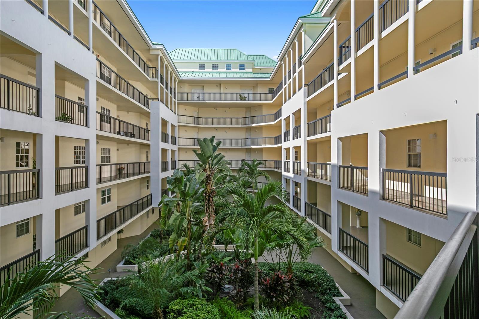 Lush, well-maintained courtyard landscaping creates a serene retreat within the condominium grounds