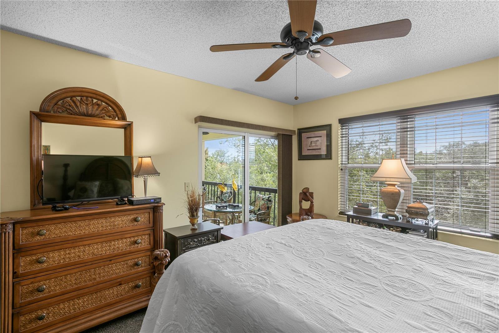 The primary bedroom offers direct access to the balcony for added outdoor enjoyment