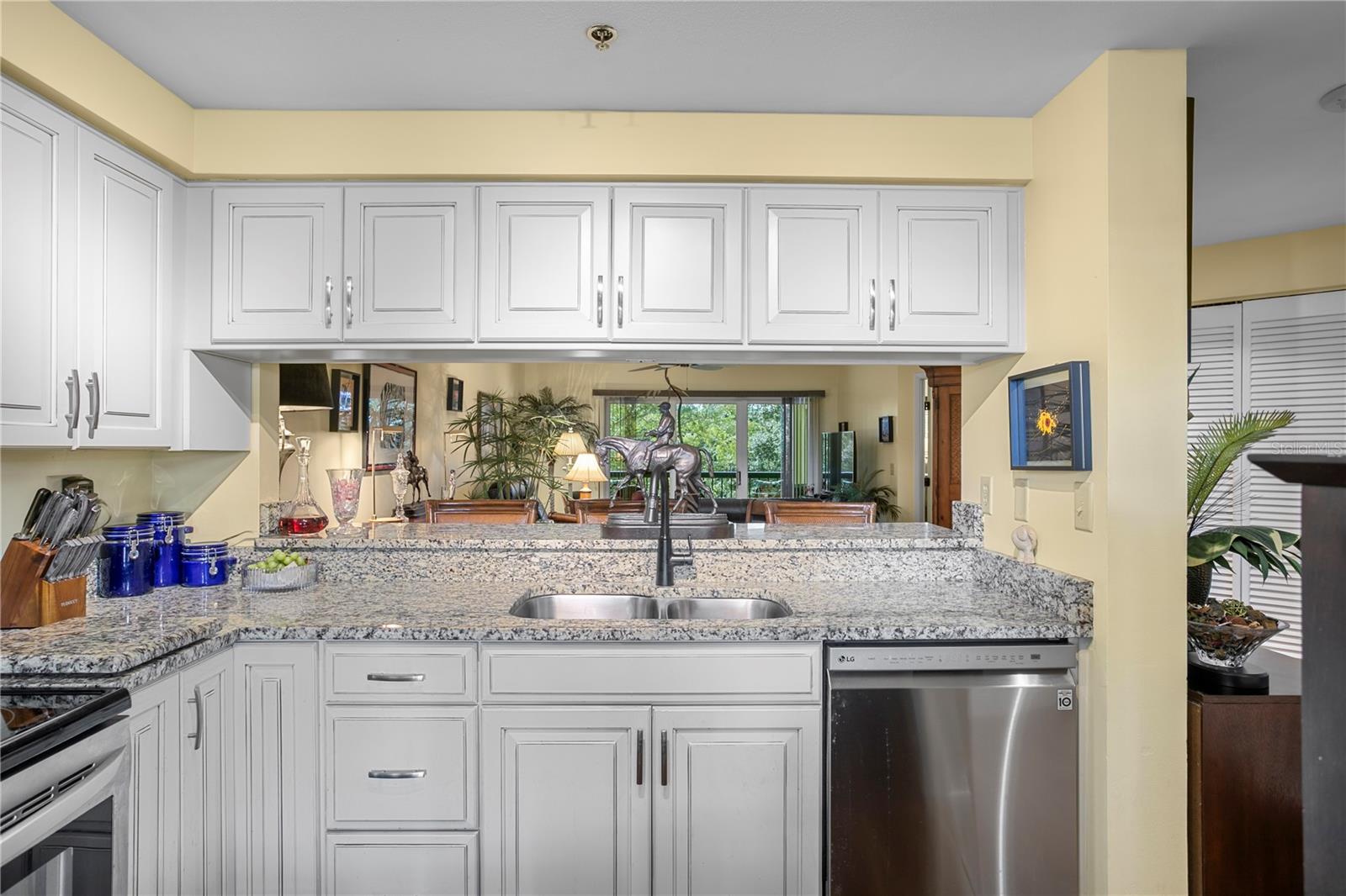 Well-appointed cabinetry provides storage, with open sightlines to the dining area and a bar-height counter ideal for casual meals or conversation.