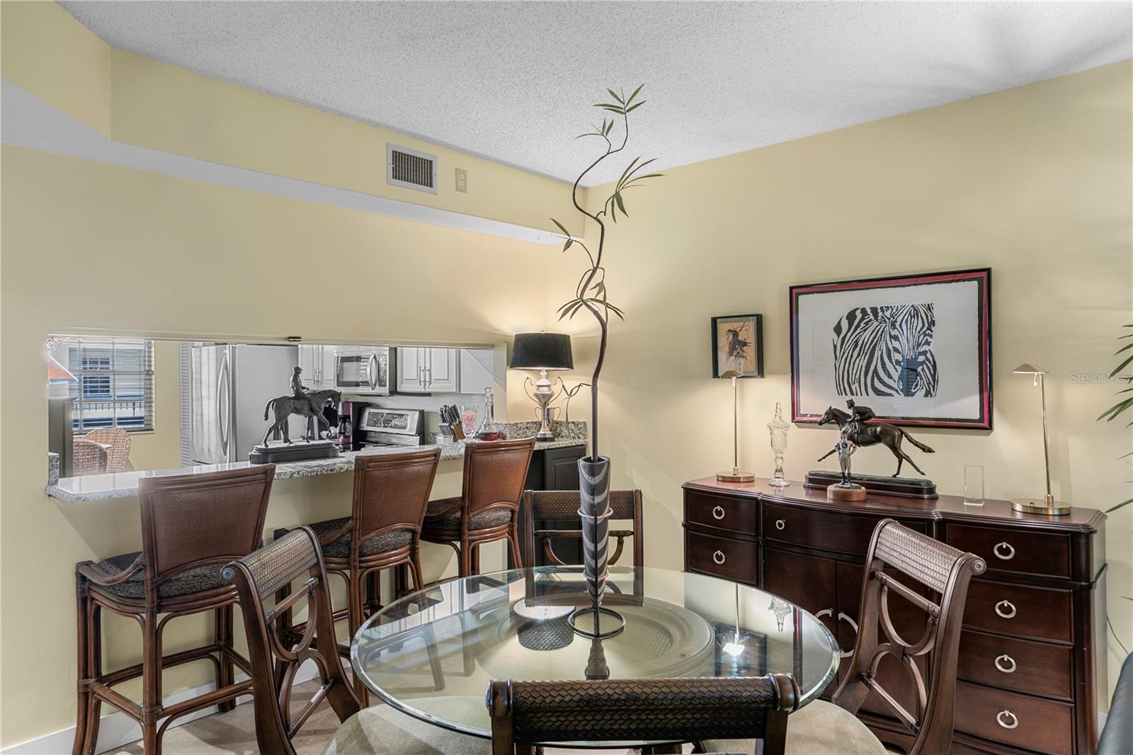 Kitchen flows effortlessly into bar seating and a dining area for a connected living experience
