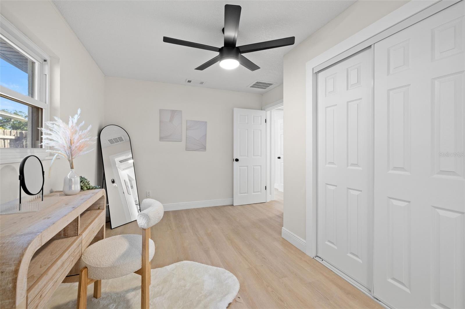 first primary walk in closet & seating area