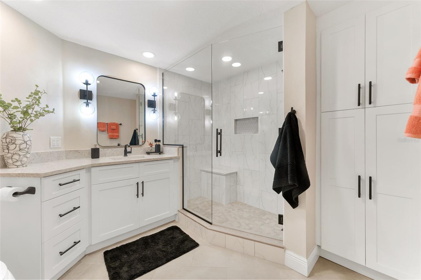 The primary bathroom was completely renovated with thoughtful additions like extra closet space for linen storage, an oversized shower and vanity.