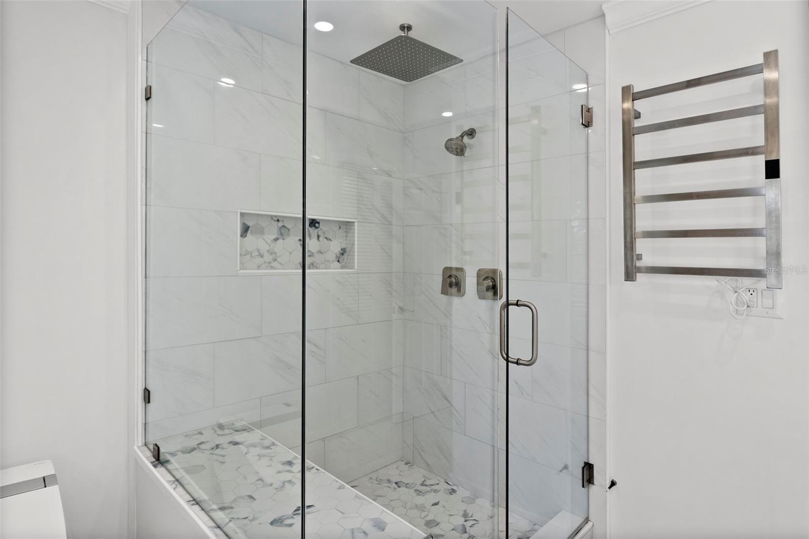 glass-enclosed shower with a rain showerhead