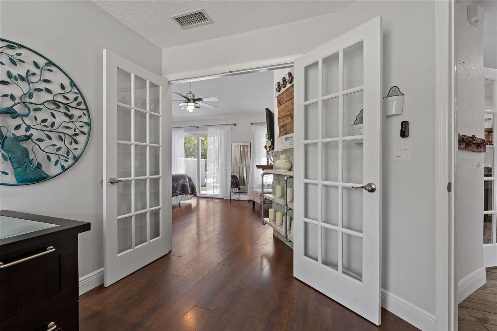 FRENCH DOORS LEADING INTO THE PRIMARY SUITE