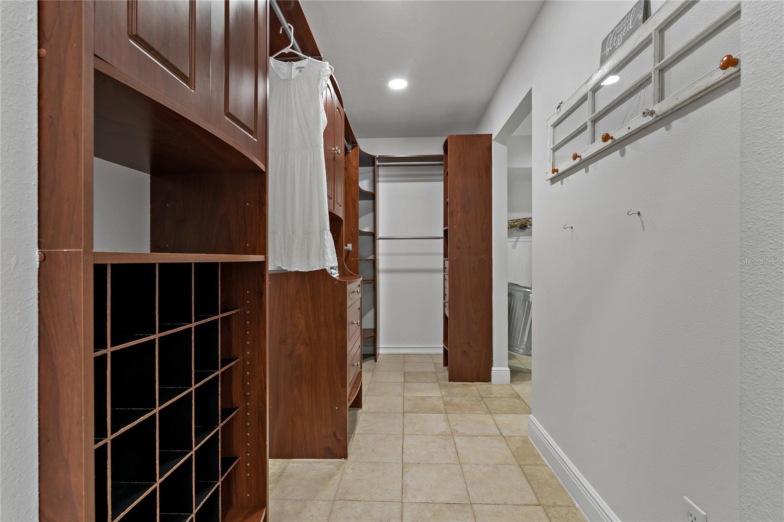 HUGE PRIMARY SUITE WALK-IN CLOSET WITH CLOSET ORGANIZATION SYSTEM IN PLACE