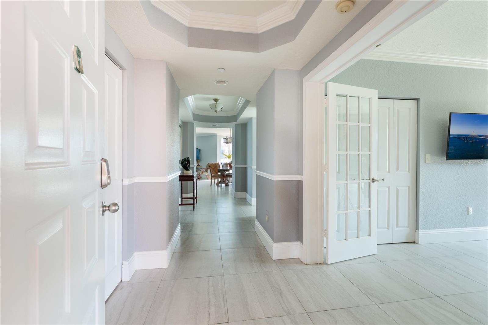 Foyer & office on right which could be a 3rd bedroom. 2019 24x24 Porcelain tile throughout the unit. Tray ceilings.