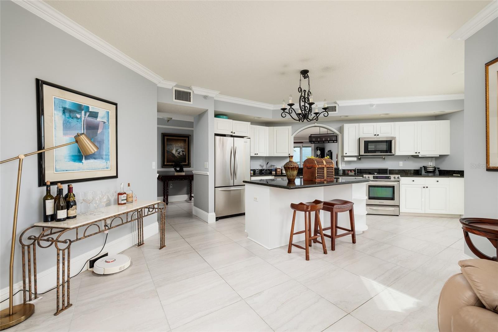 Kitchen w/Breakfast bar on Island. Crown molding. 24x24 Porcelain tile.