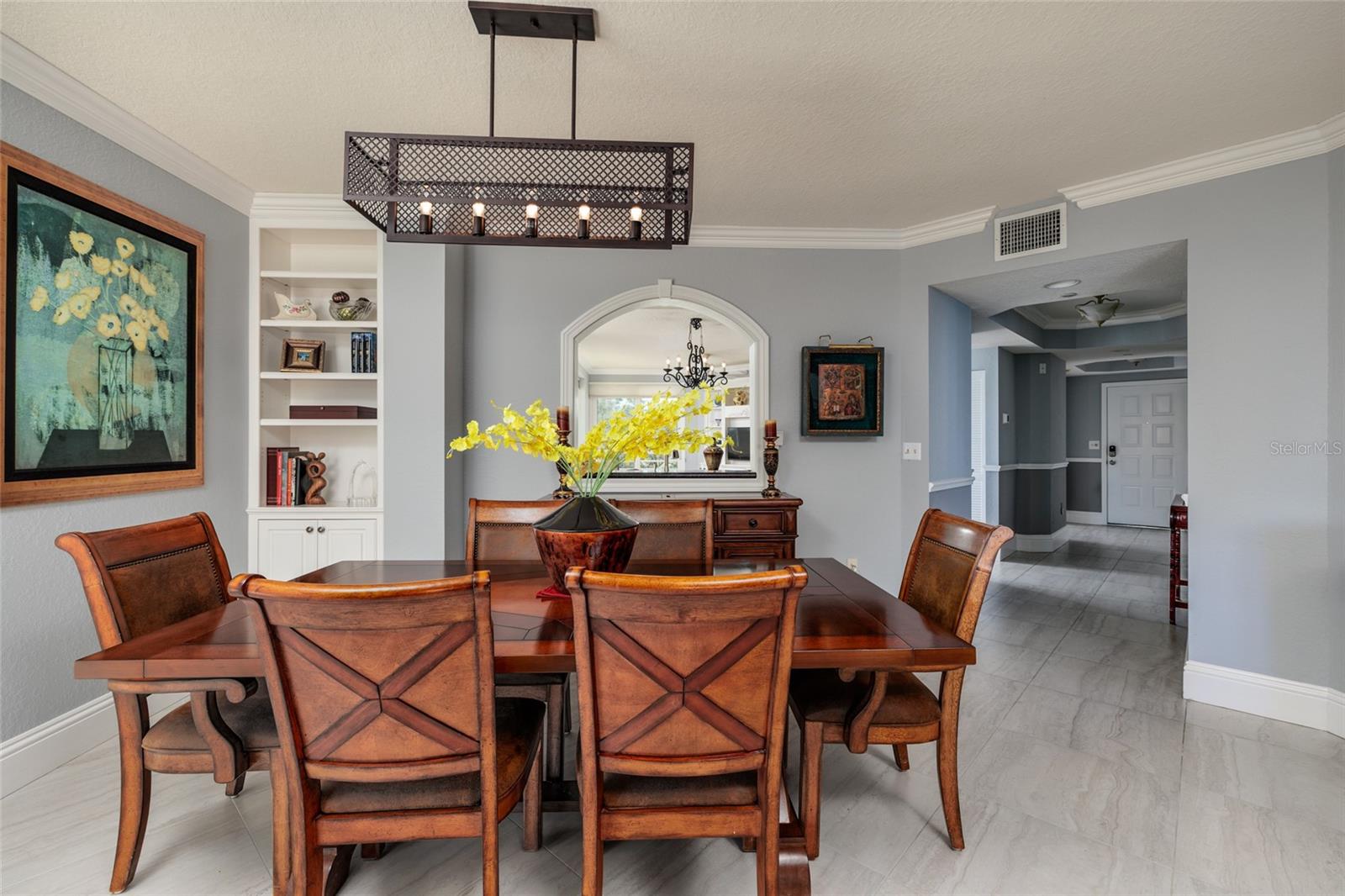 Dining area w/bult in shelves & crown molding. 24x24 Porcelain tile.