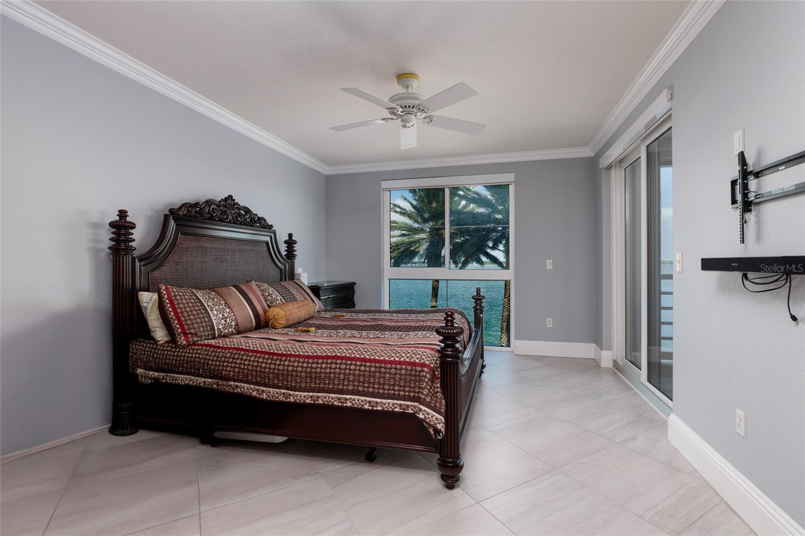 Primary bedroom w/24x24 Porcelain tile & crown molding.