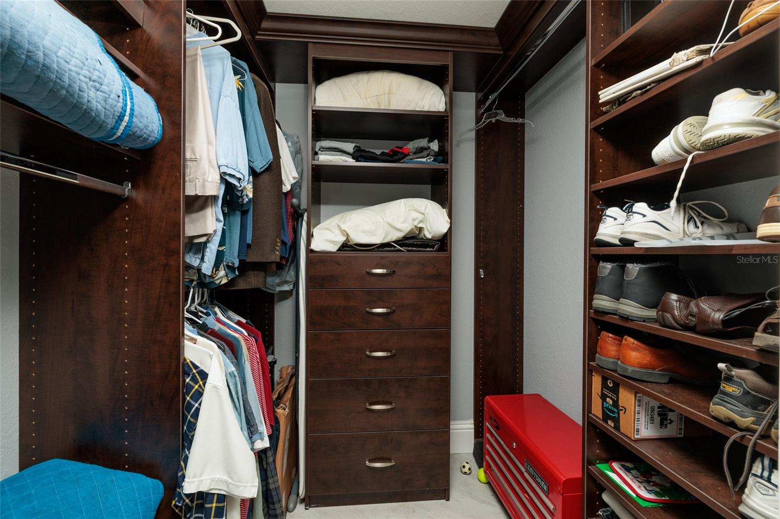 Primary bedroom walk-in closet & there's another built-in closet across from it.