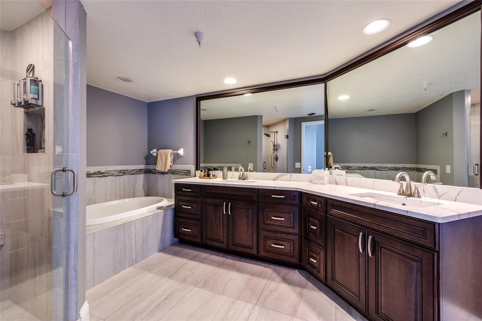 Primary bathroom (updated) w/Garden tub & separate shower stall. Granite counter.