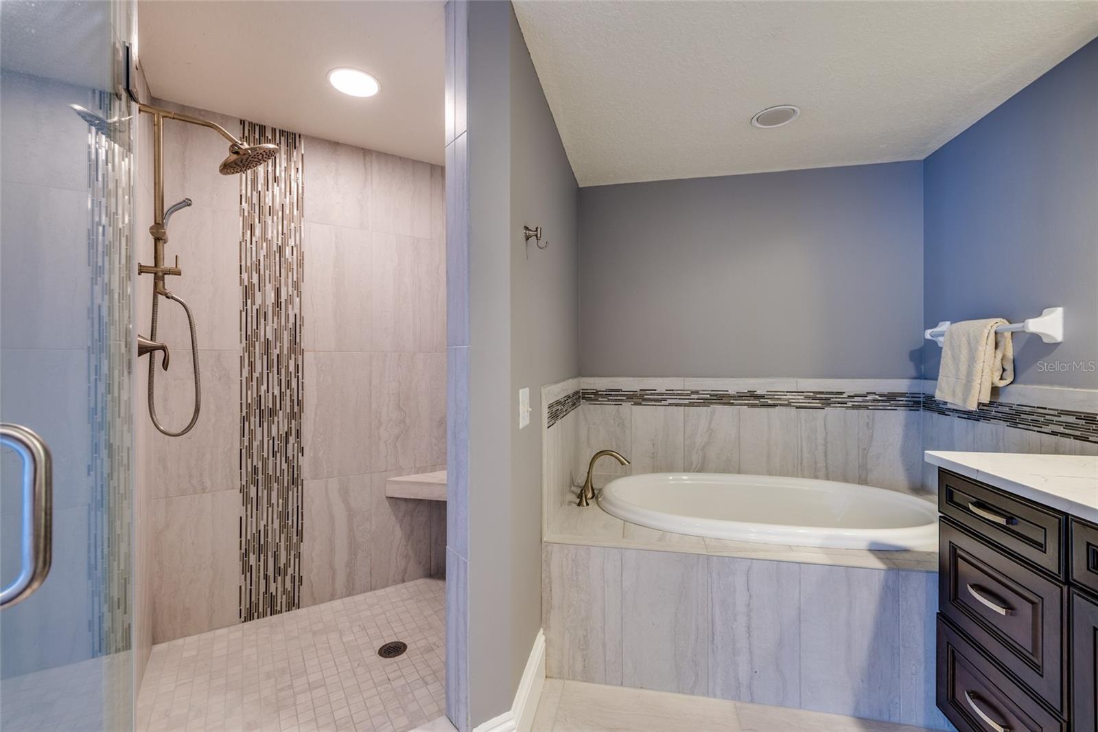 Primary bathroom shower w/bench.