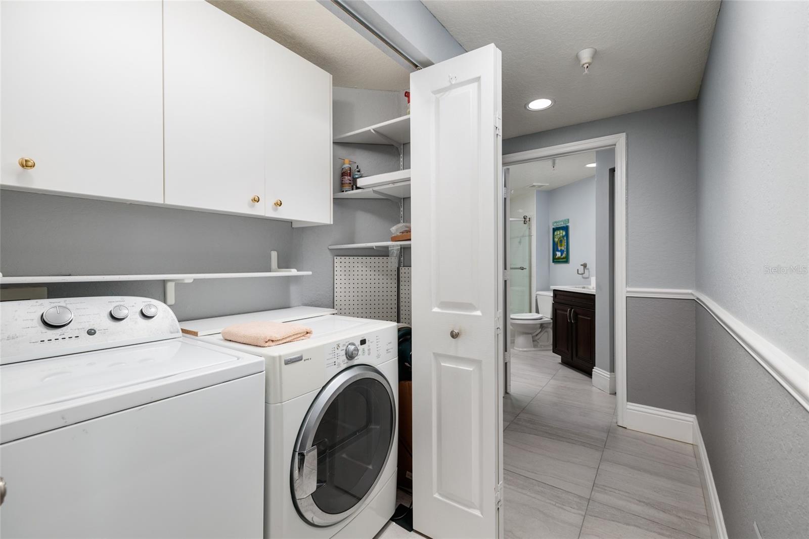 Laundry closet in hallway to 2nd bedroom & bathroom.