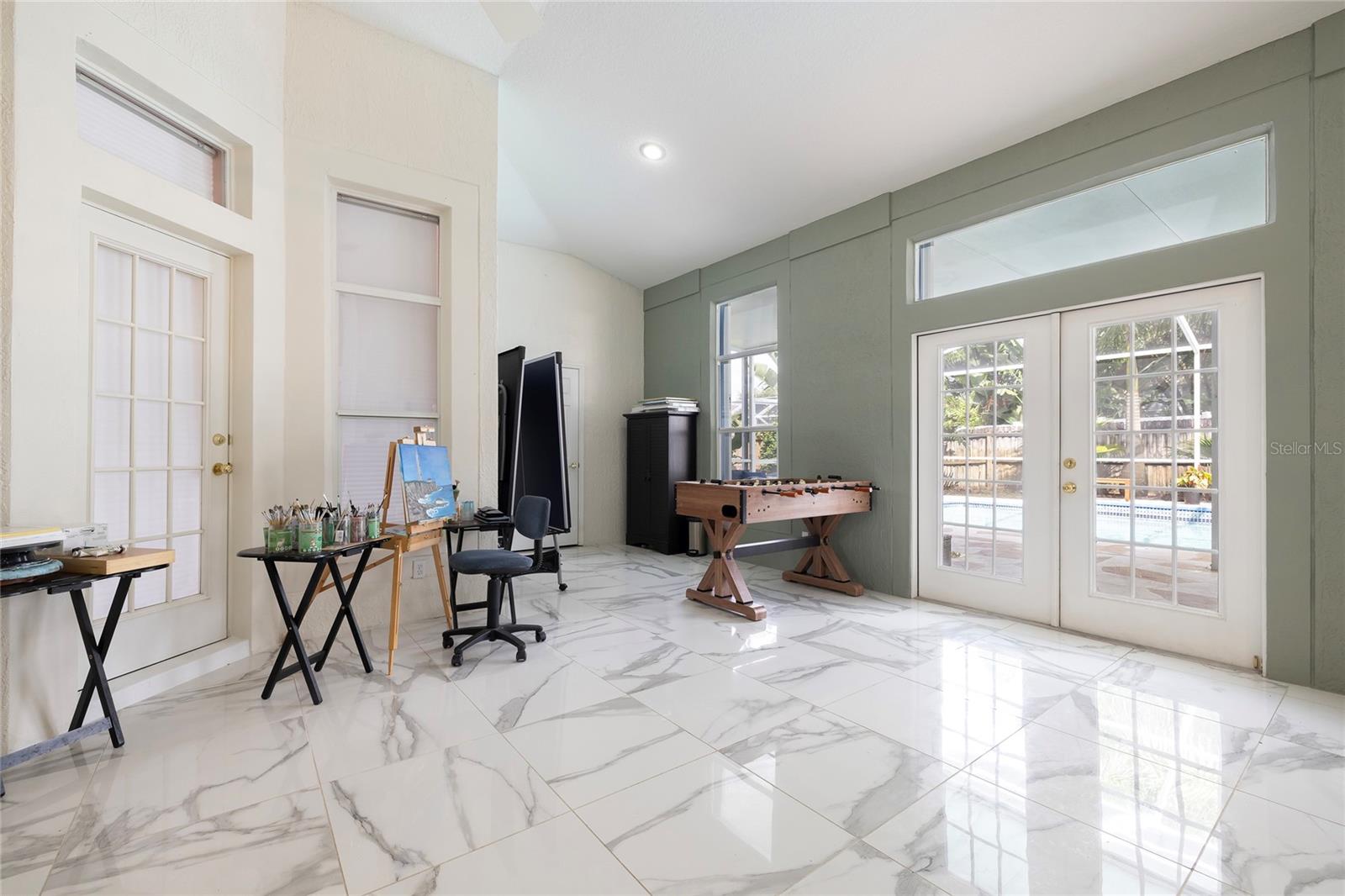 arge Open game room/hobby room overlooking the pool