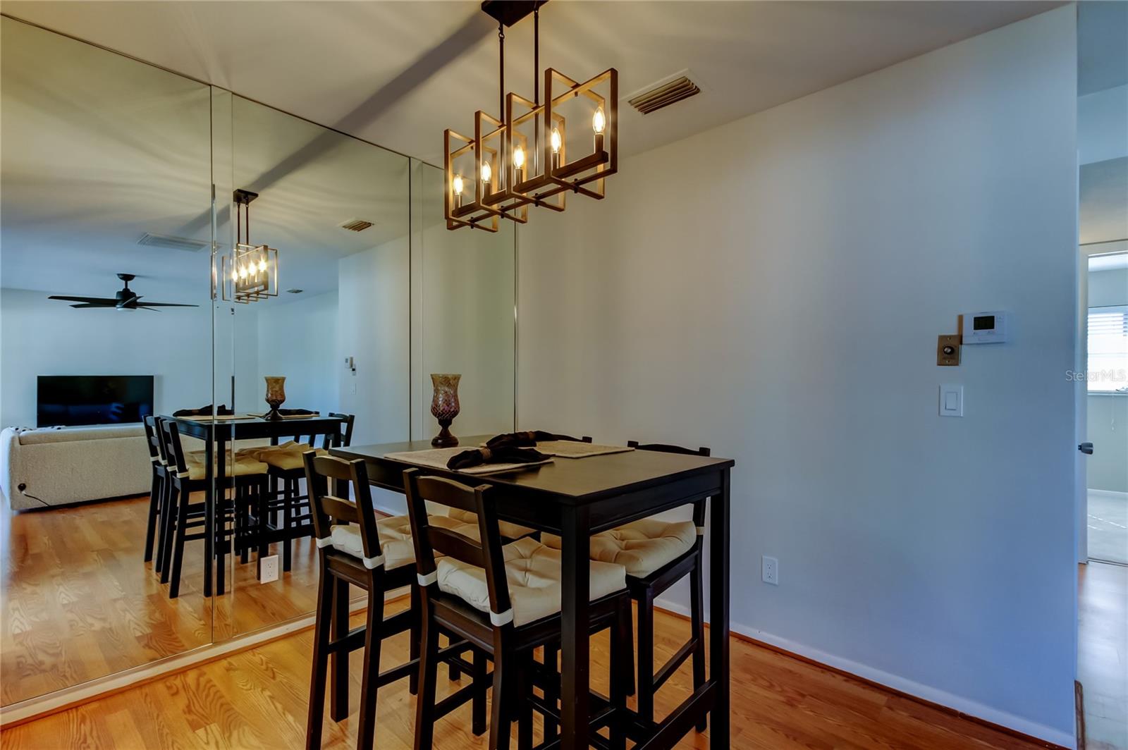 18. Dining Area Features a Mirror Wall! It Creates a Spacious Aesthetic!