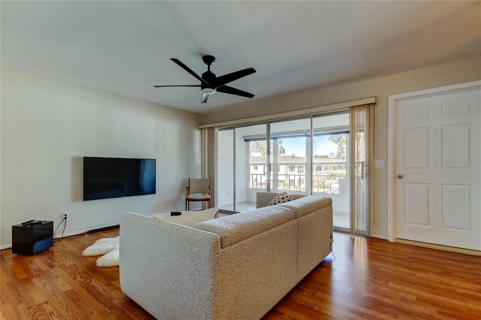 5. Living Room (13' x 13') Has Plenty of Natural Light from a Wall of Sliding Glass Doors