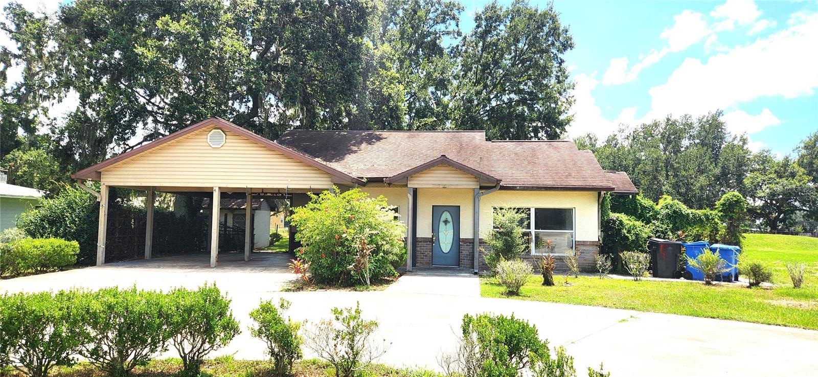 Main building in front of 1+ acre lot with 2 car carport