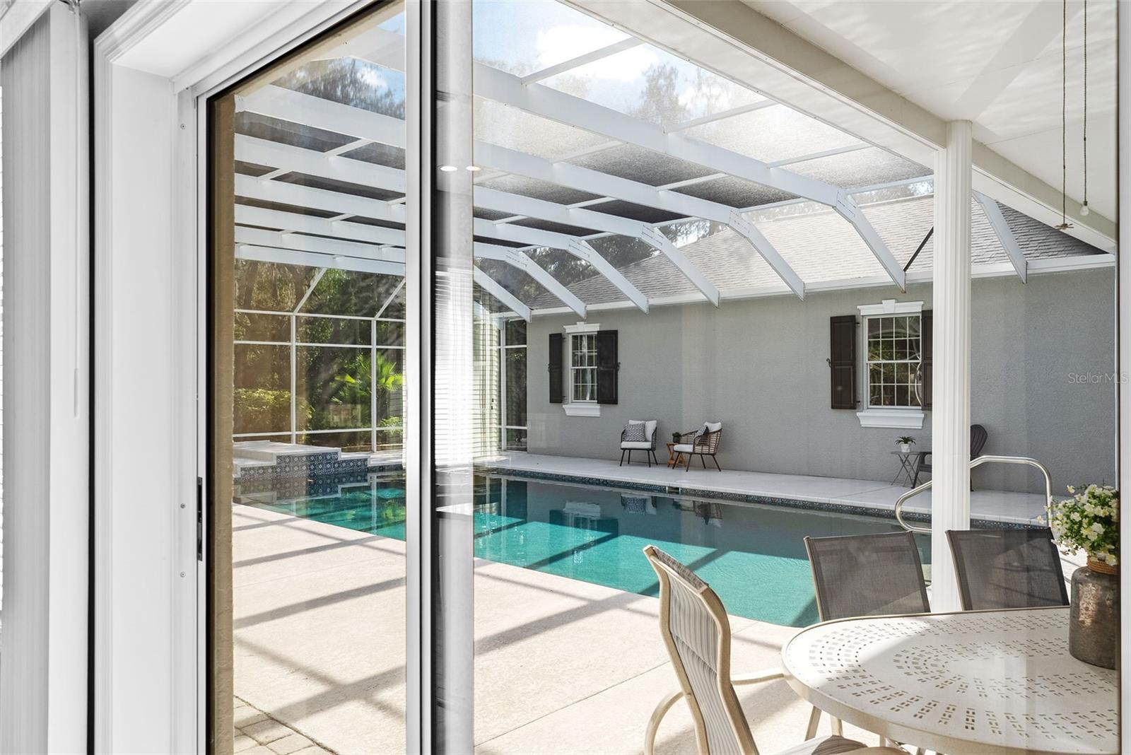 Sliding Glass doors to pool from Primary Bedroom