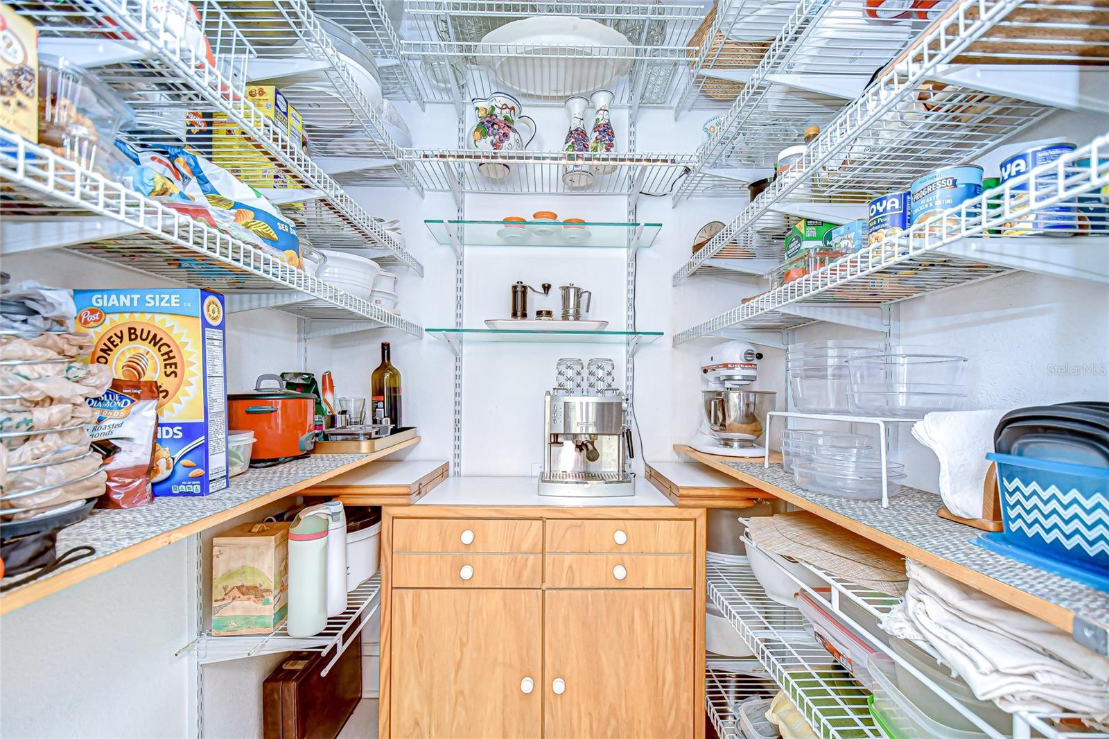 Spacious walk-in pantry with pull-down attic stairs