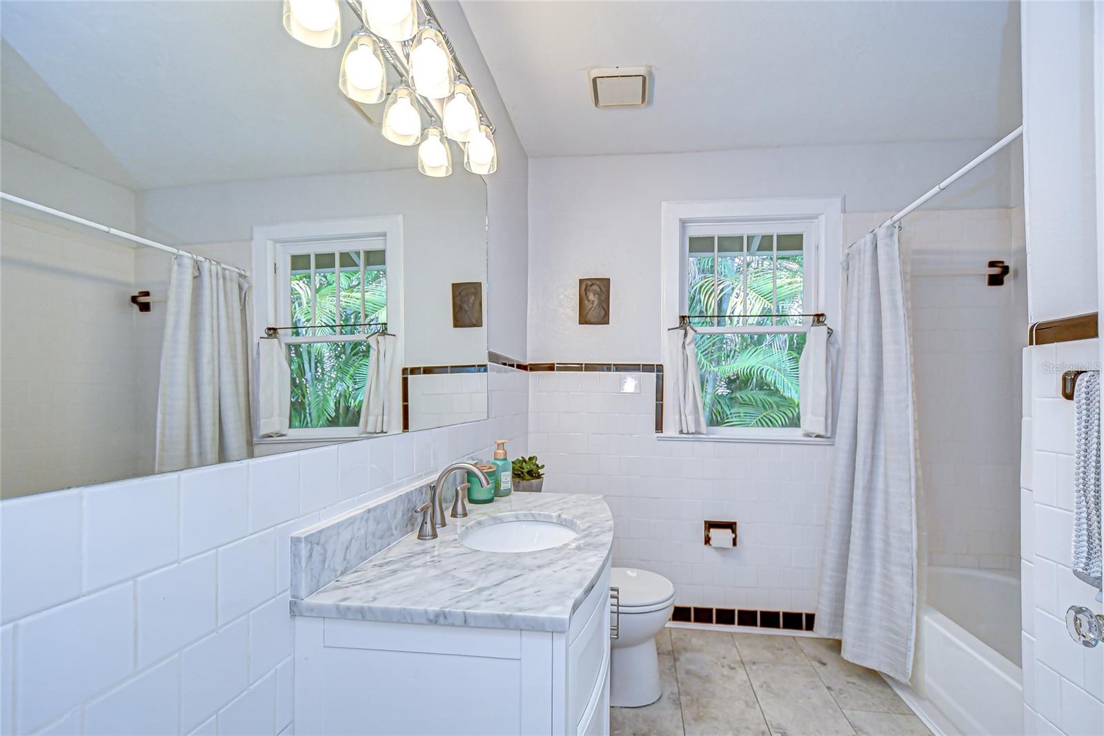 Second bath between dining room and primary bedroom