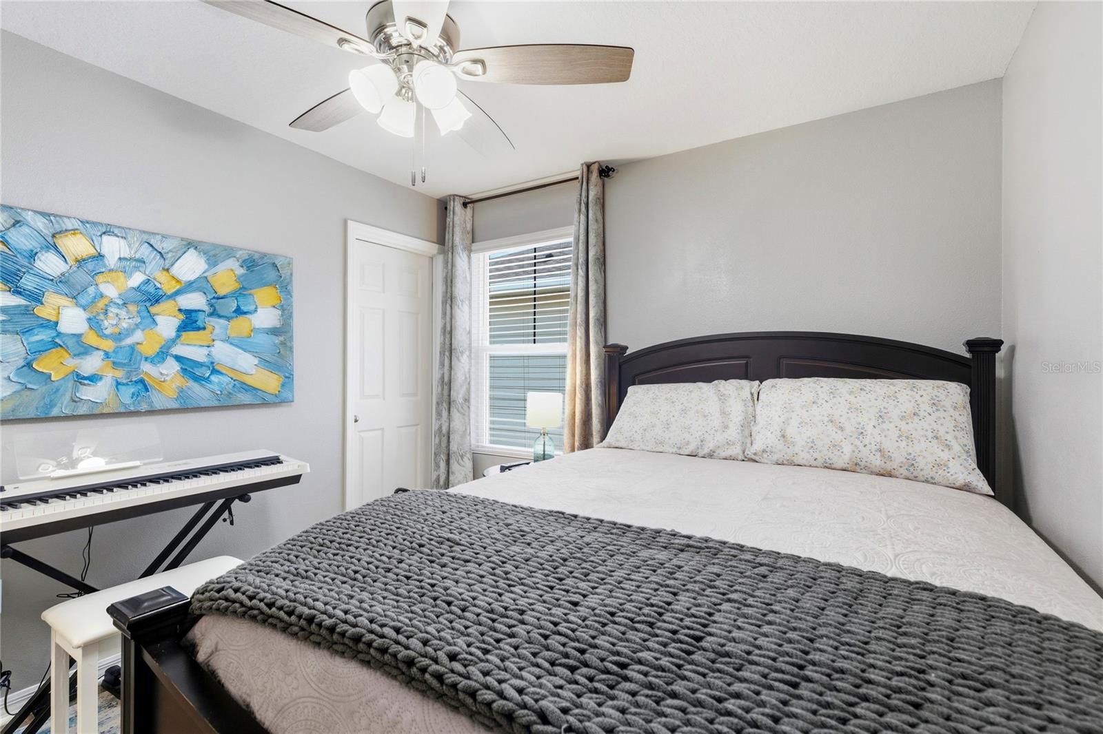 2nd bedroom with walk in closet and ceiling fan