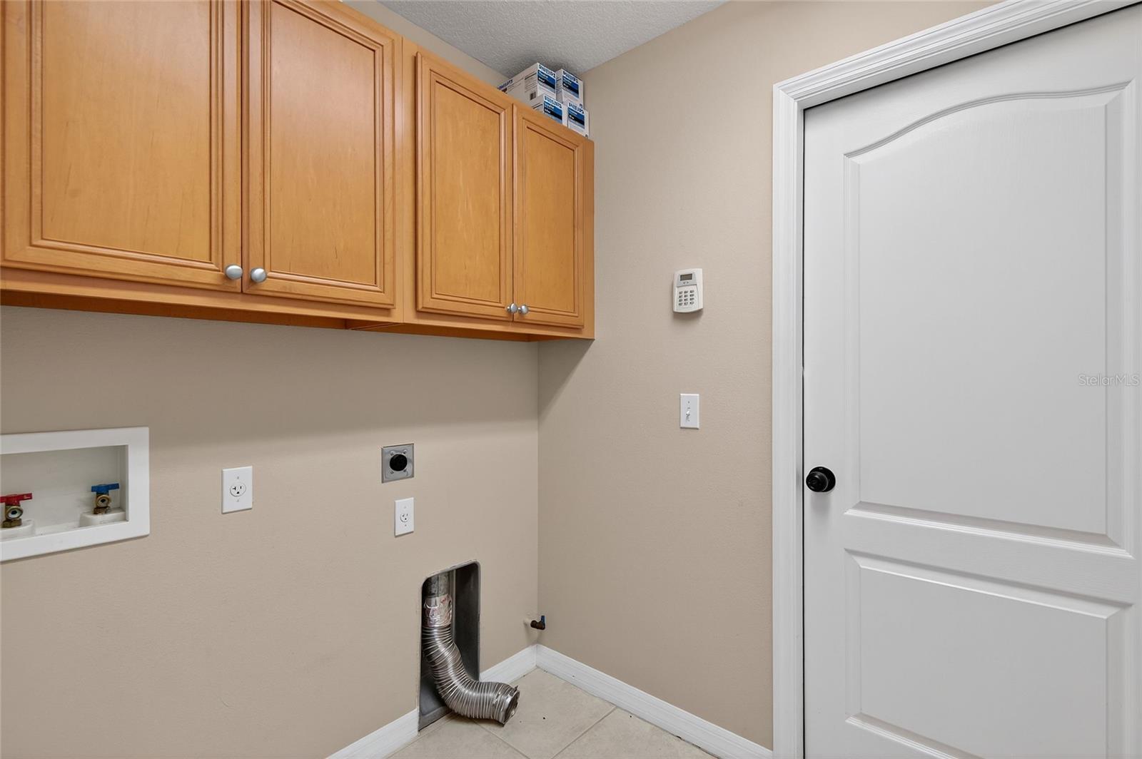Laundry Off the Kitchen with Door Leading to 2-Car Garage