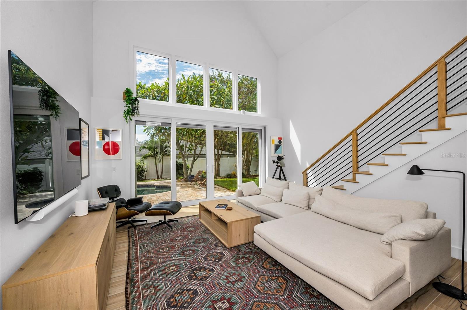 Living Room with Oversize Sliding Door and Stairs to Loft