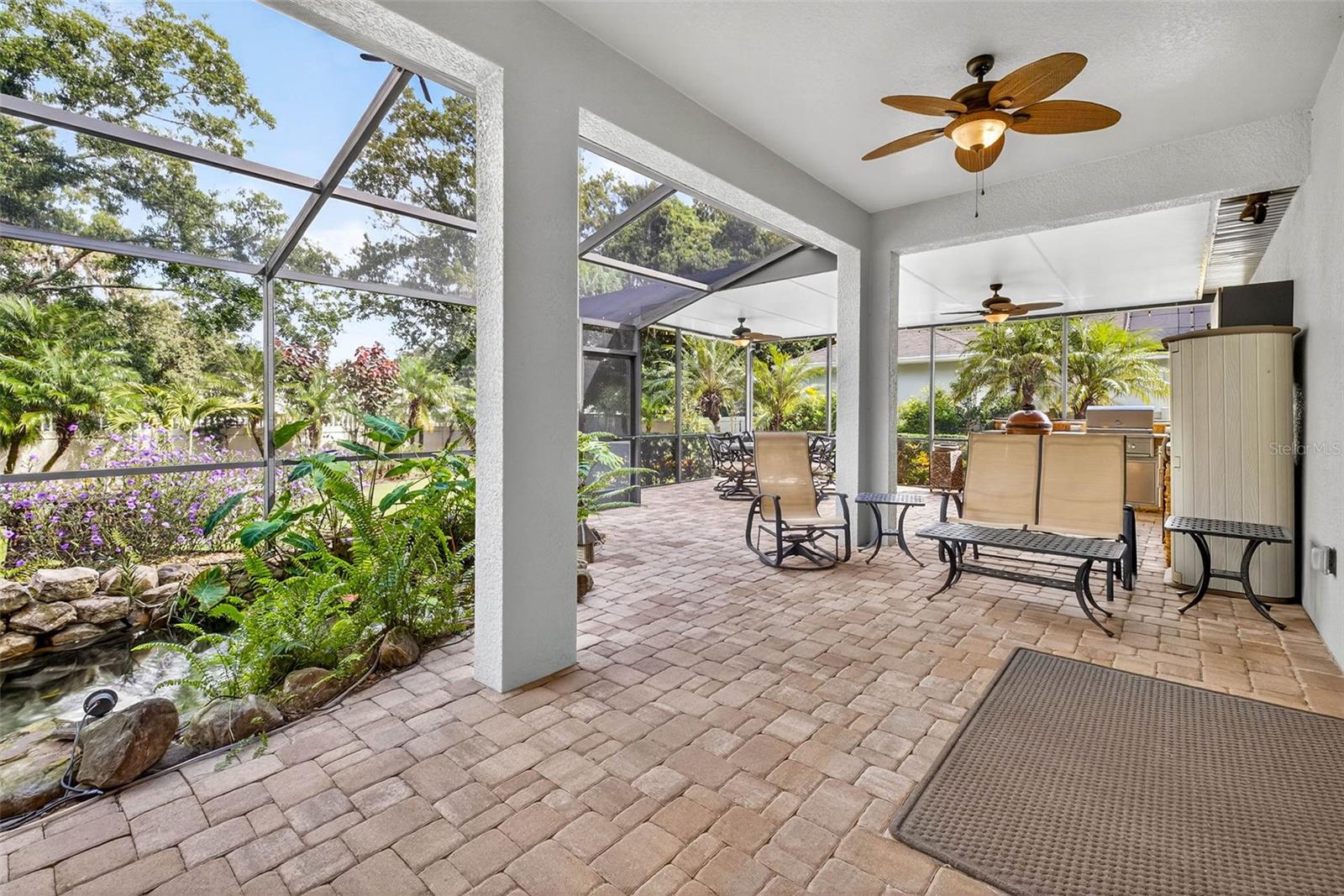 Screened Lanai View with Koi Pond and Outdoor Kitchen