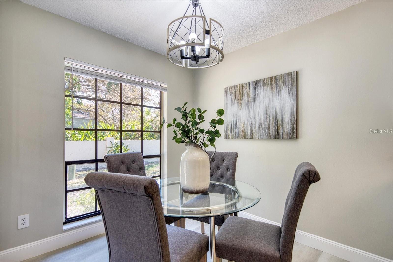 Room for casual dining in front of this sunny window~