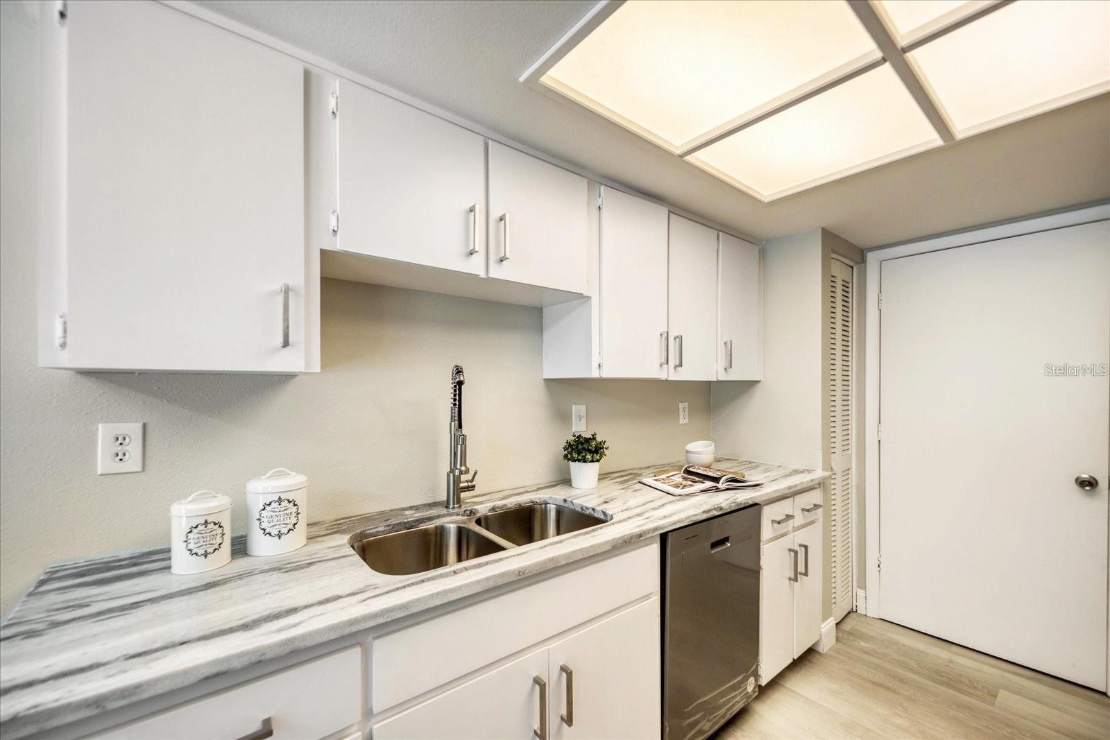 New appliances, fixtures & quartzite counters. Pantry closet & door to garage~