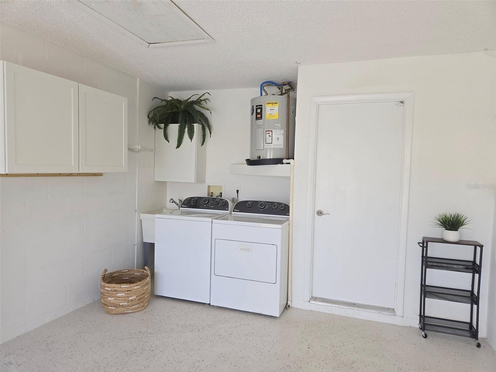 Whirlpool laundry set, new cabinet storage, utility sink & a hanging rod for an efficient station~