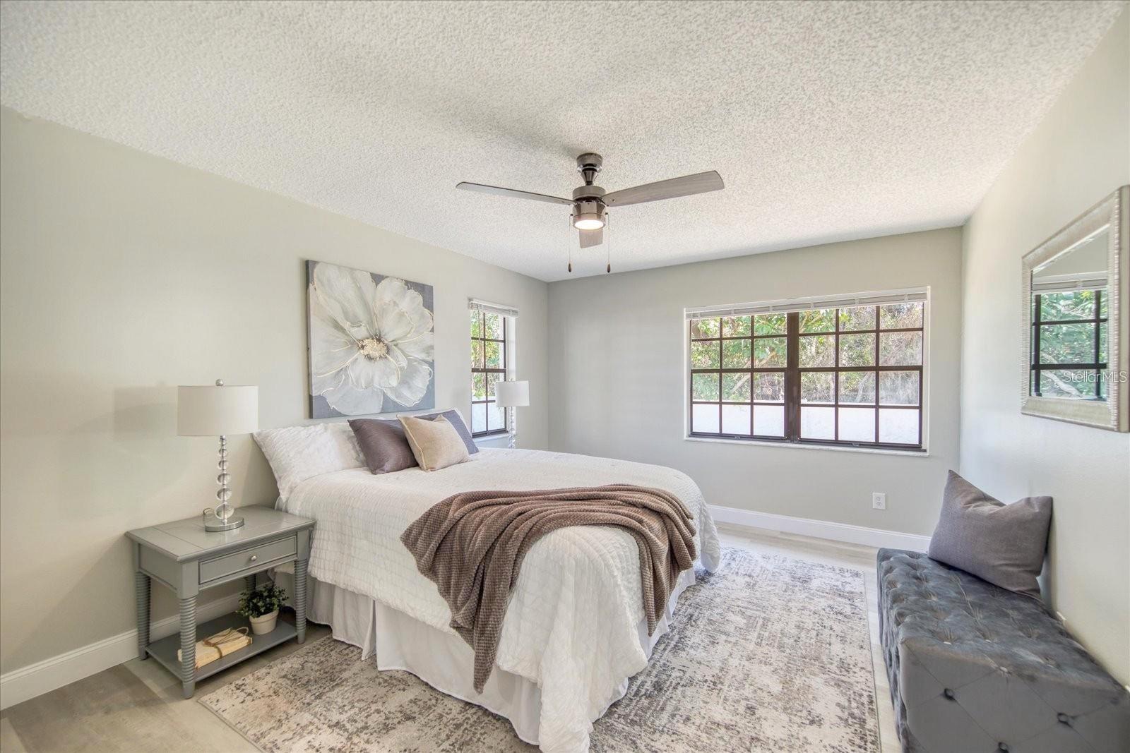 The larger of the two bedrooms is on the back of the house. Great windows are better enjoyed with the privacy wall~