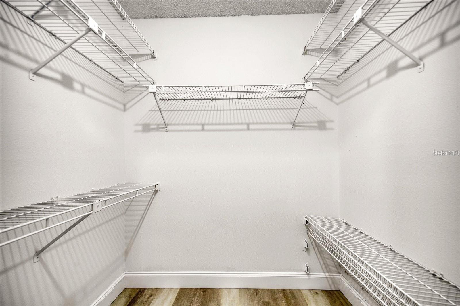 A generous walk-in closet serves the primary bedroom~