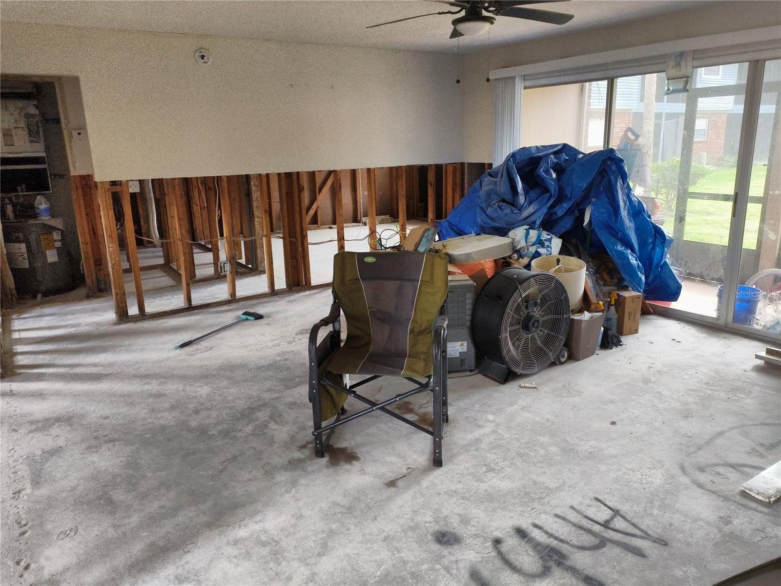 large open living room with sliding glass doors to the newly completed screened-in patio