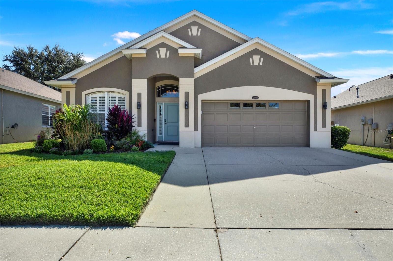 Beautifully maintained front exterior with lush landscaping, 2023 roof, and inviting curb appeal located on a quiet dead-end cul-de-sac.