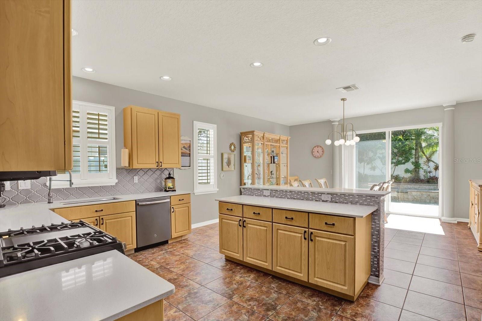 Light, bright, and open! This kitchen flows beautifully into the dining space with backyard views that make every meal feel special.