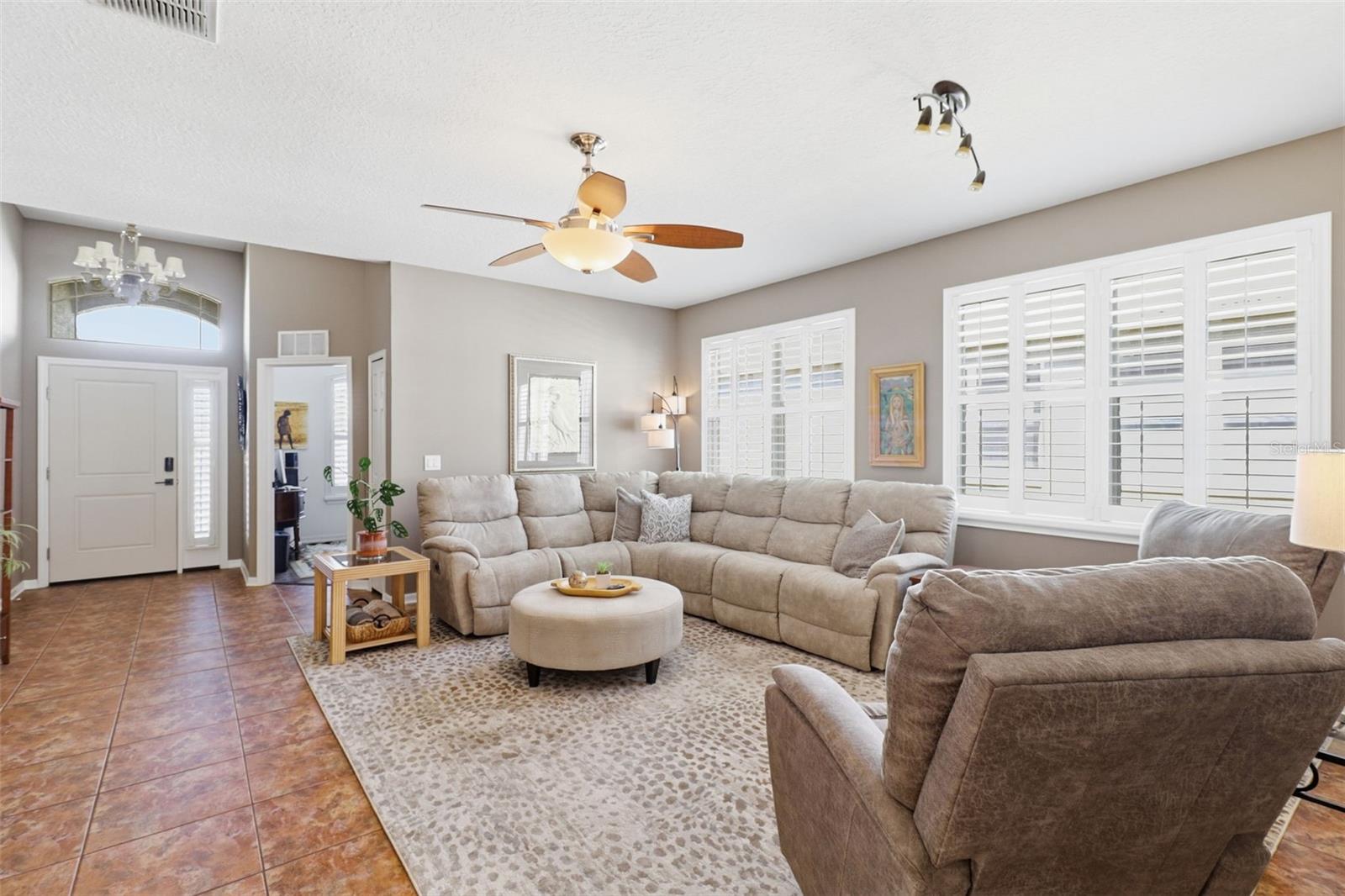 Sun-filled living room with plenty of space to gather, relax, and enjoy the open flow that makes this home perfect for entertaining