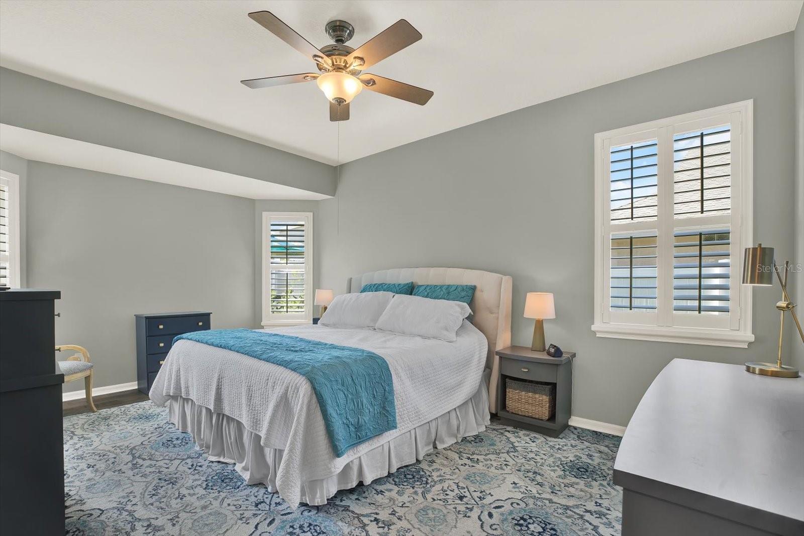 The primary suite is a true retreat, designed for comfort and relaxation. This spacious room offers plenty of natural light and a peaceful view of the backyard oasis, creating a calm and private atmosphere. There’s even a cozy sitting area—perfect for reading, morning coffee, or quiet downtime.