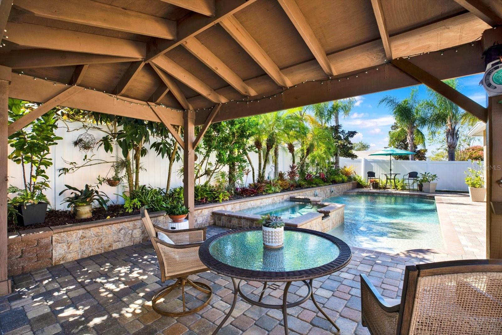 Kick back in the shade with a cool drink and a view—this relaxing gazebo is the perfect spot to soak in your own tropical paradise.