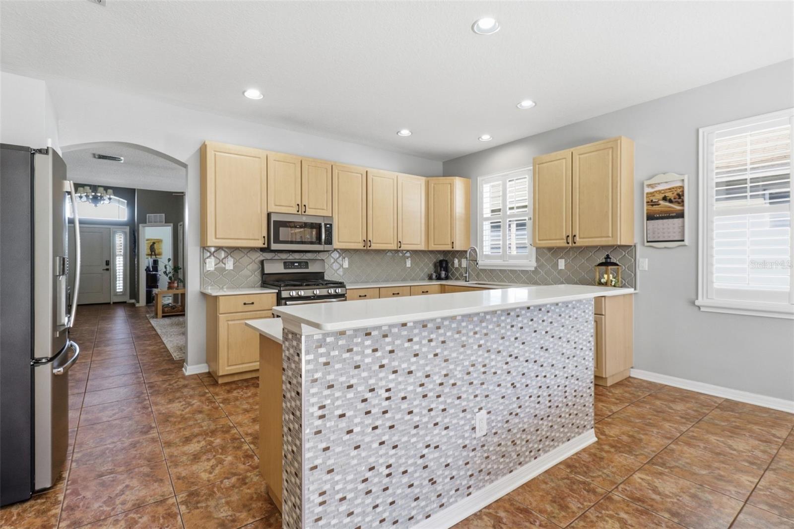 Bright and open kitchen with quartz countertops, upgraded appliances, gas range, and a stylish island that’s ready for gatherings and good food!
