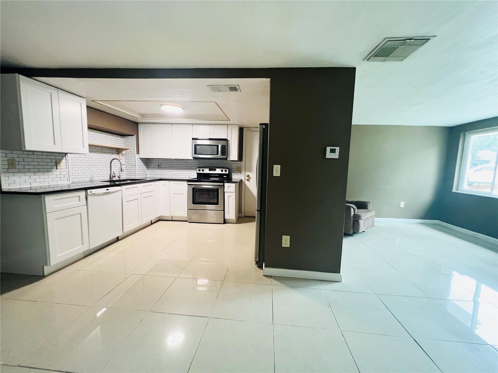 SPLIT VIEW OF KITCHEN AND LIVING FROOM