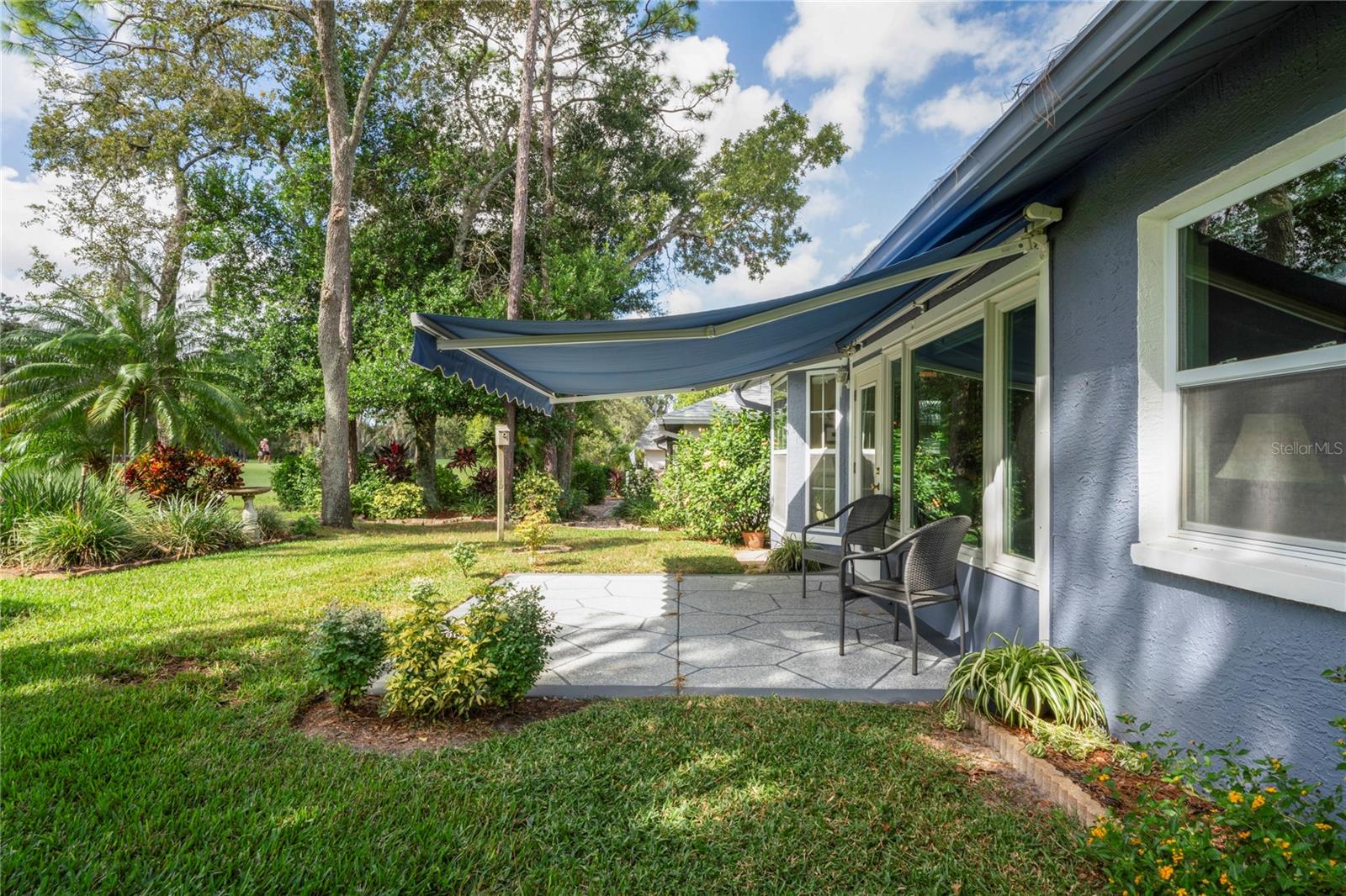 Patio shaded by  retractable awning