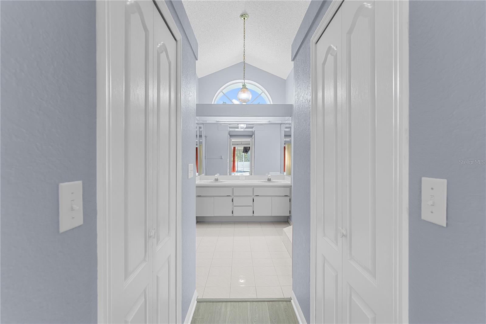 Primary walk in closets entrance to bathroom