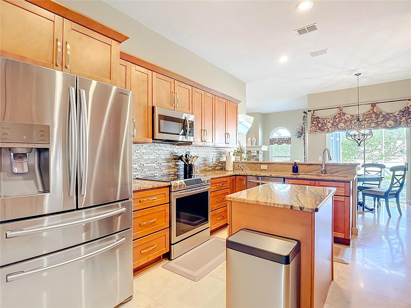 Kitchen with wine fridge and lots of pull out storage drawers