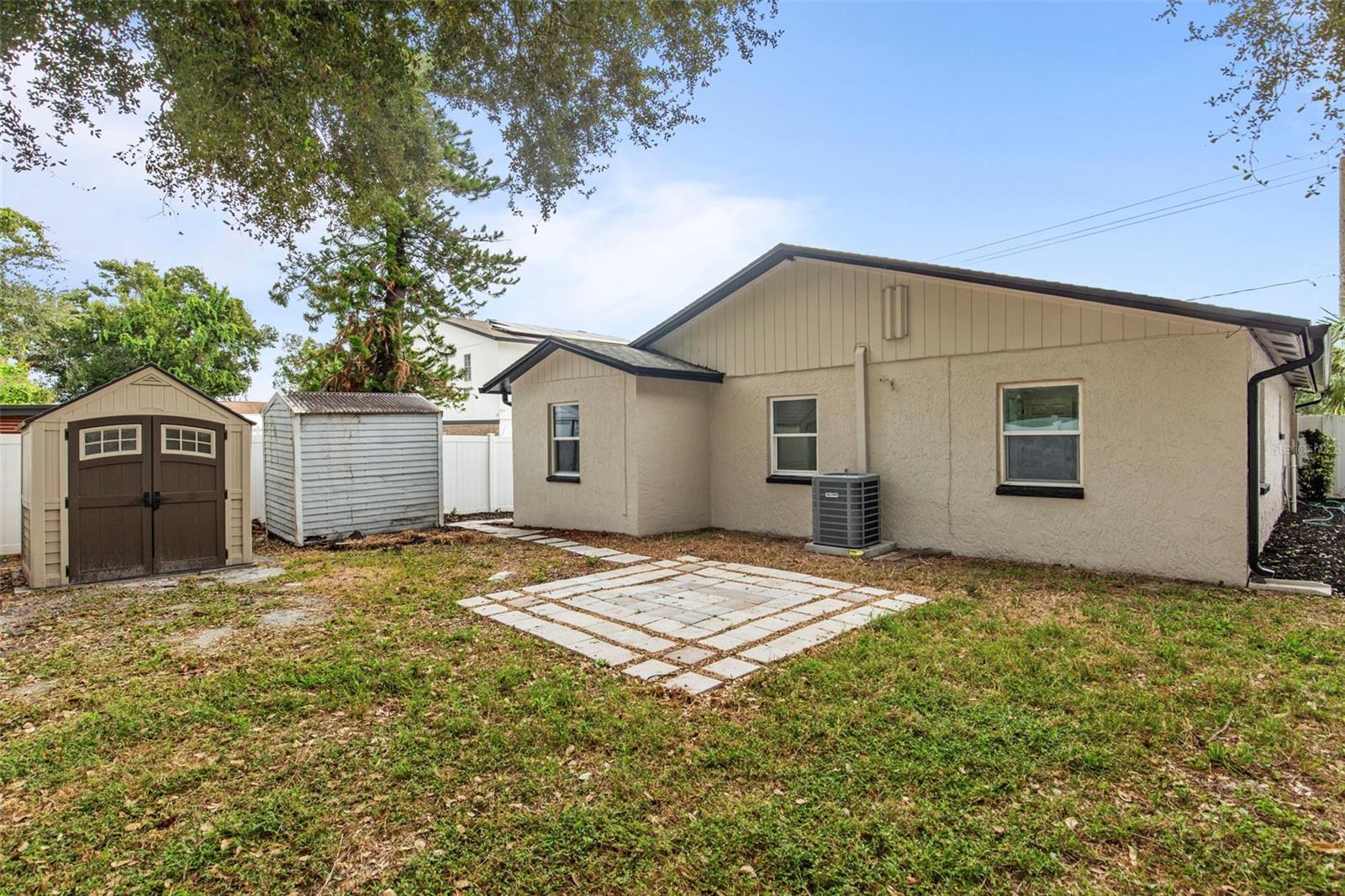 large backyard with storage sheds