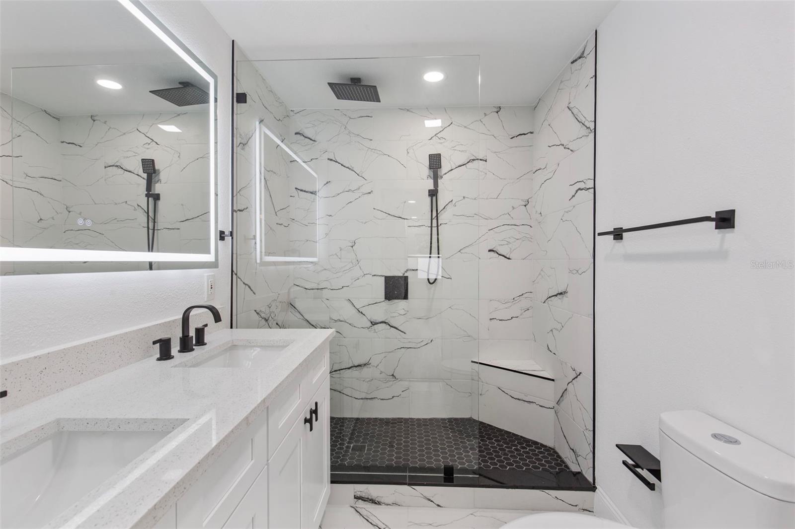 double master bedrooms with step in showers and custom glass enclosure